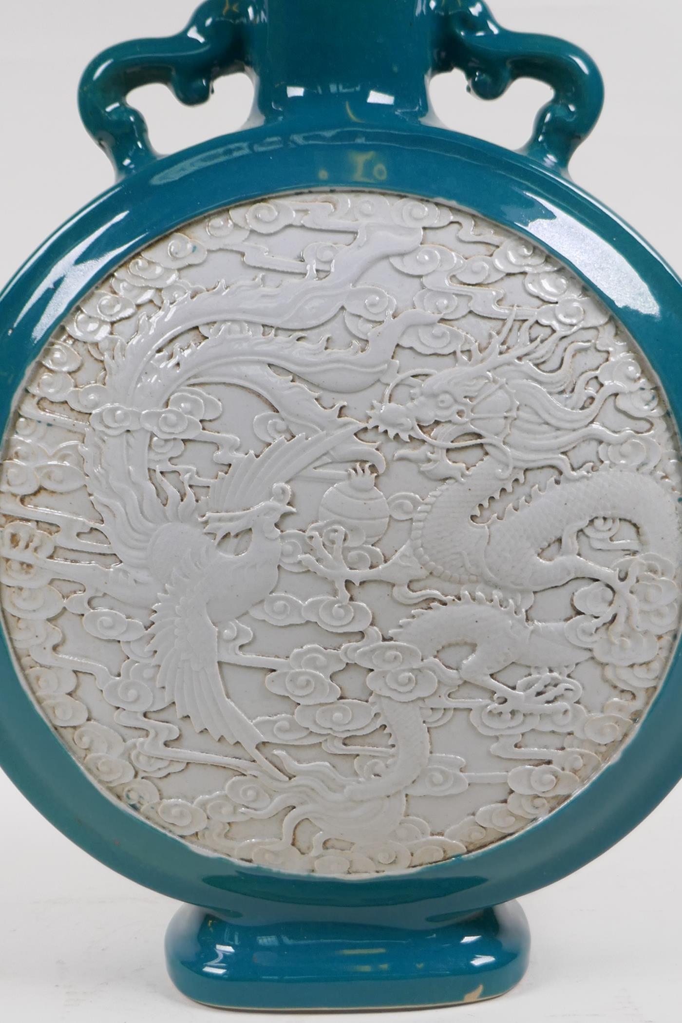 An emerald green glazed porcelain two handled moon flask with a white ground panel and raised dragon - Image 2 of 6
