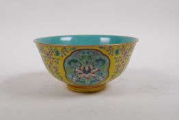 A polychrome porcelain rice bowl with decorative floral panels on a yellow ground, Chinese Yongzheng
