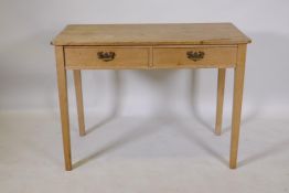 Early C19th stripped pine two drawer side/writing table with brass plate handles, raised on square