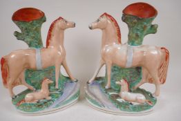 A pair of large Staffordshire flat back spill vases modelled as horses with foals, 30cm high