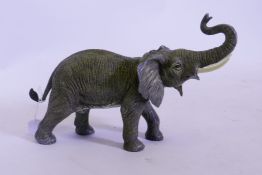 A cold painted bronze figure of an elephant, after Bergman, impressed mark to base, 35cm long