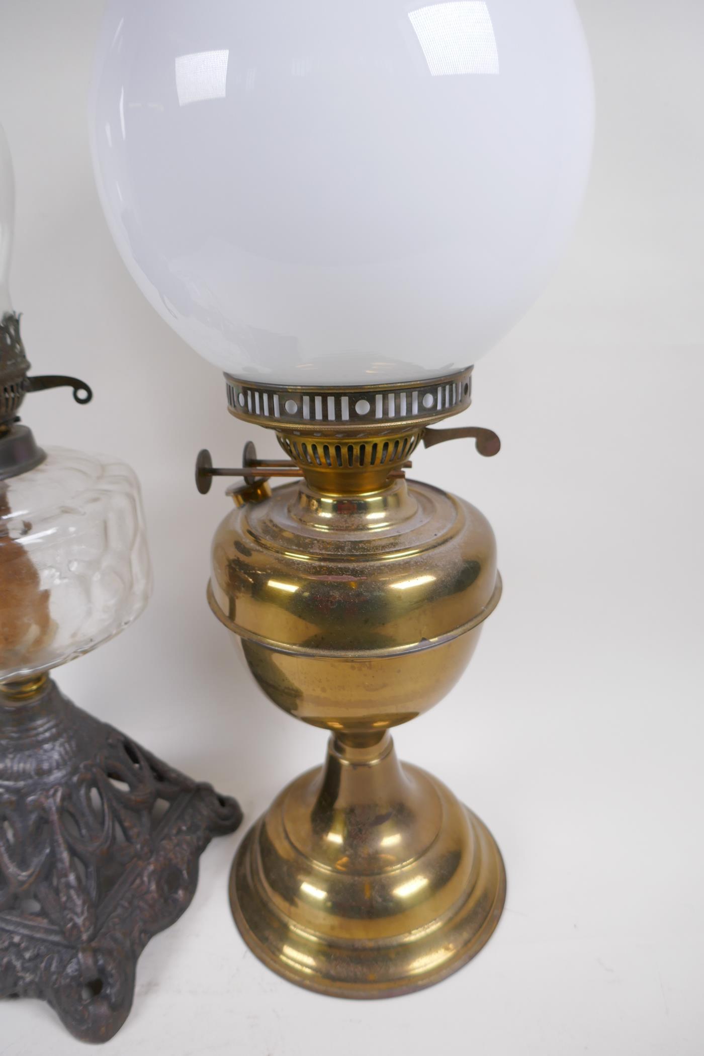 A Victorian oil lamp with cast iron base, glass font and duplex burner and glass funnel, together - Image 3 of 5