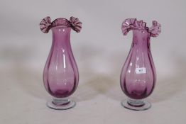 A pair of amethyst glass vases with frilled rims, 37cm high