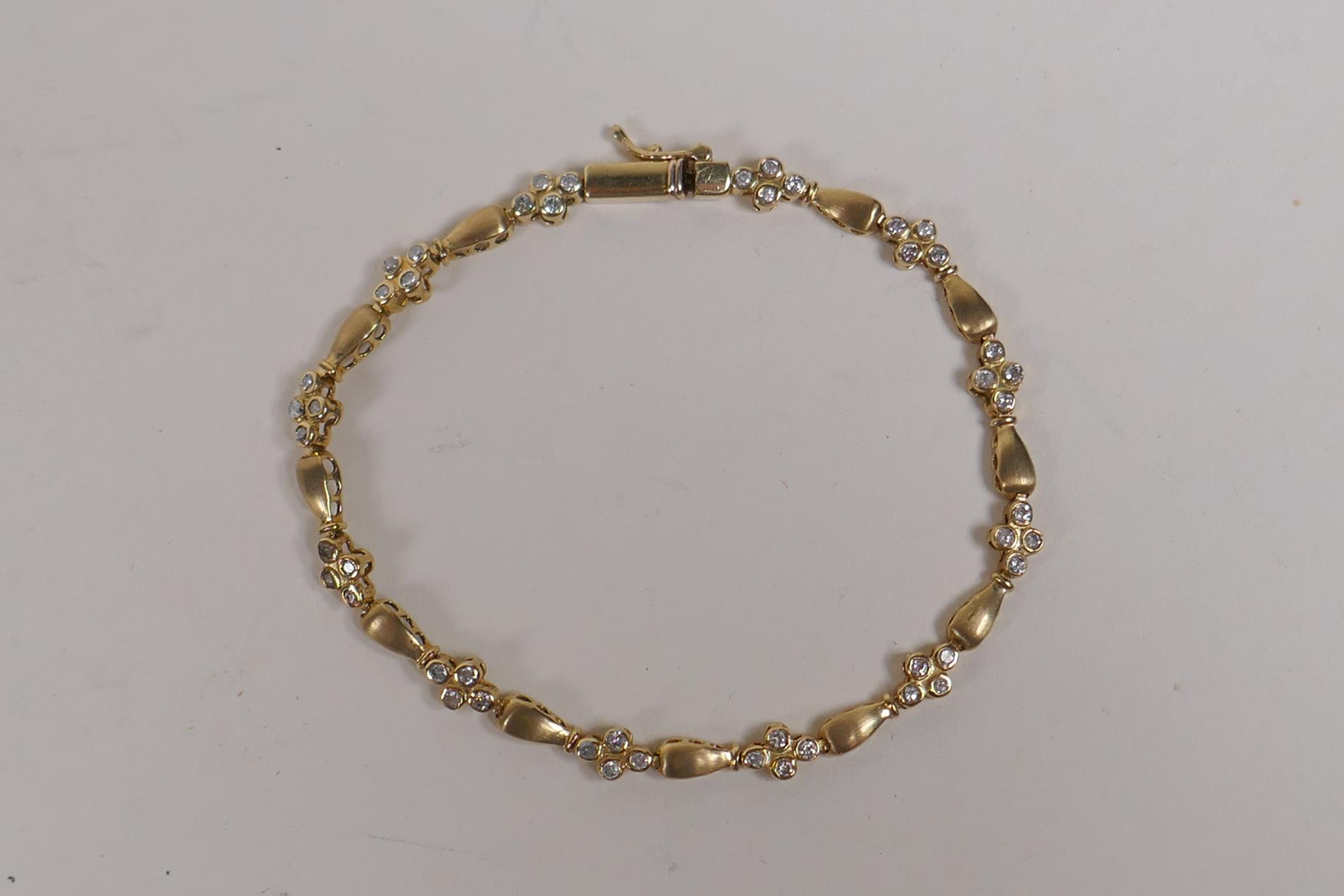 A 10ct yellow gold and diamond set line bracelet, 18cm long - Image 2 of 2