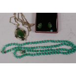 A suite of gilt metal and jade earrings and pendant, and a string of jade beads