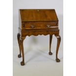 A Queen Anne style fall front bureau, with figured mahogany veneer, shaped interior fitted with four