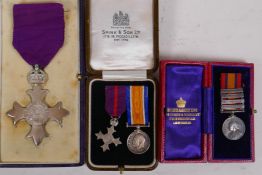 An M.B.E. medal, a miniature Victorian South Africa medal with four bars, a miniature M.B.E. and a