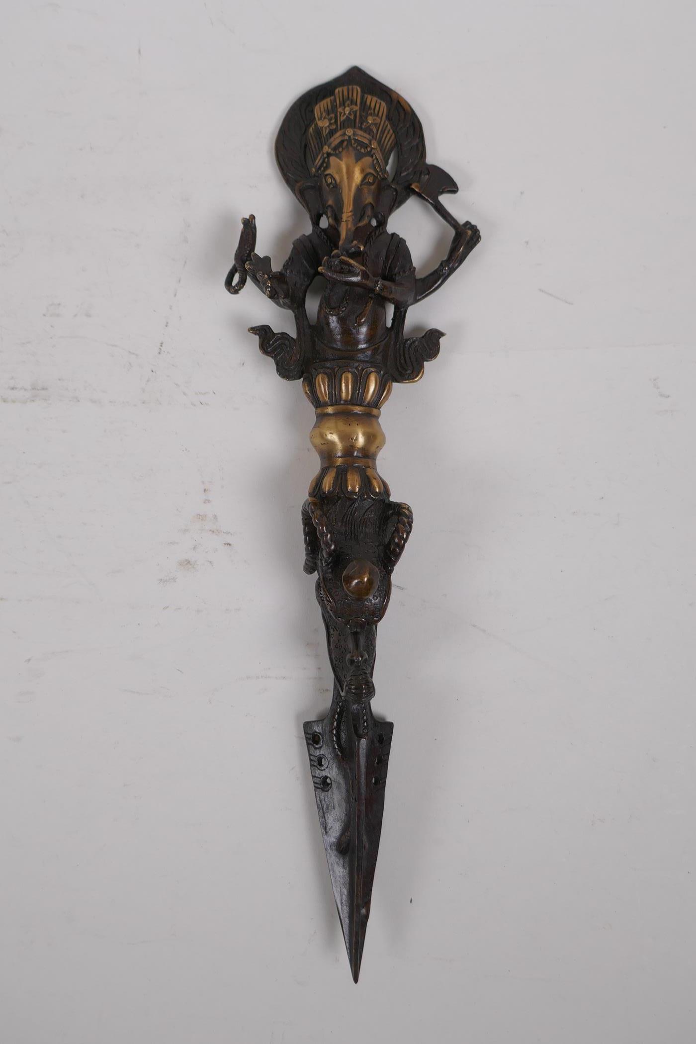 A Tibetan bronzed metal phurba, the handle in the form ofGanesh, 32cm long