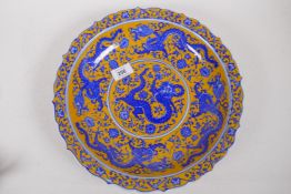 A Chinese blue and white bowl with yellow overglaze and dragon decoration, seal mark to base, 32cm