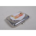 A hallmarked silver cigarette case with a later applied cold enamel plaque depicting a pin-up