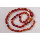 A faceted amber bead necklace, 52cm long, clasp AF