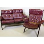 A mid century stained wood frame two seater settee with buttoned leather seats and back, 127cm, 85cm