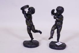 A pair of bronze figures of putti playing the triangle and cymbols, unsigned, 23cm high