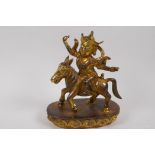 A Chinese gilt bronze figure of a deity on horseback, 23cm high