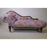 A Victorian walnut chaise longue with carved shaped back, raised on carved and turned supports