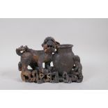 A Chinese soapstone carving of a fo dog and vase, 25cm long