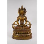 A Sino Tibetan gilt bronze figure of Buddha seated on a lotus throne, 37cm high