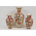A garniture of three Meiji Satsuma vases, largest 31cm high