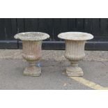 A pair of classical style concrete pedestal garden urns, 48cm high