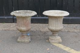 A pair of classical style concrete pedestal garden urns, 48cm high