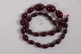 A cherry amber graduated bead necklace, 39cm long, clasp AF