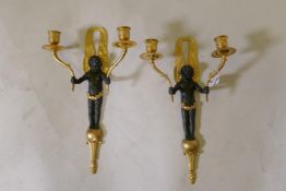 A pair of bronze and ormolu two branch wall sconces in the form of putti bearing cornucopia, 35cm