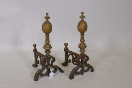 A pair of Victorian cast iron and brass fire dogs, 20 x 39cm high