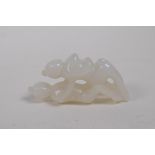 A Chinese carved white jade erotic pendant, 6cm long