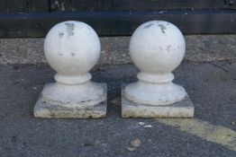 A pair of stone ball finials, 18cm diameter, 30cm high