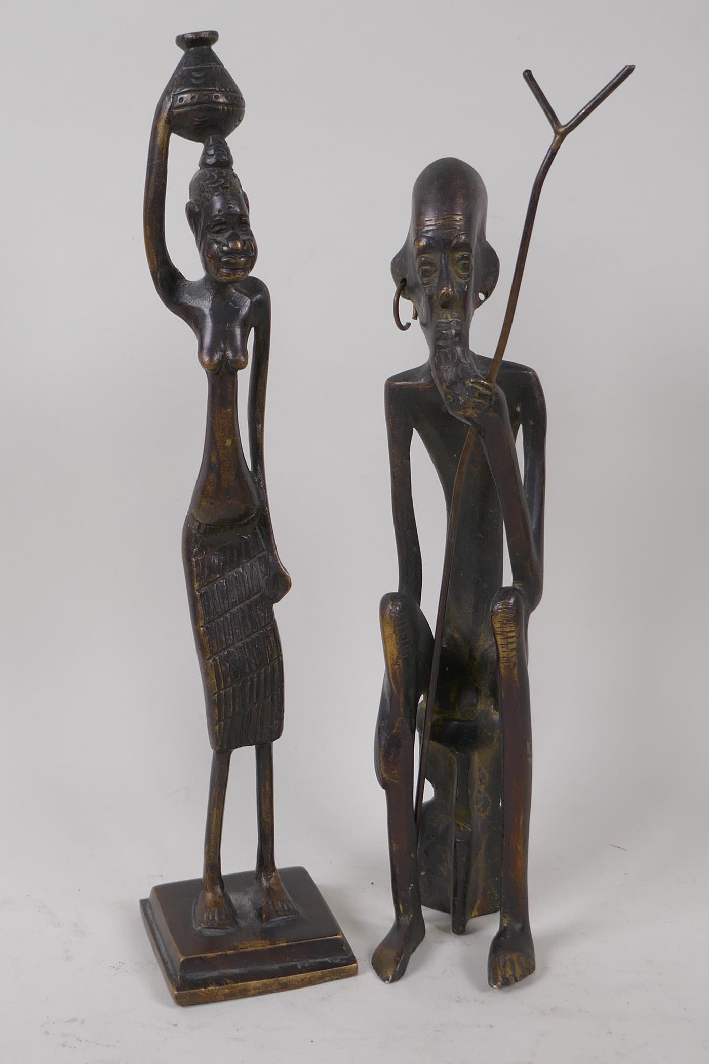 Two Benin bronze figures of a warrior and woman, 30cm high