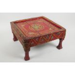 An antique painted footstool, 17cm high, 29cm square