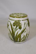 A Wardle majolica garden seat with raised olive green glazed lily decoration, 47cm high, 36cm dia