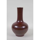 A copper lustre glazed porcelain bottle vase, Chinese Qianlong seal mark to base, 24cm high