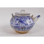 Oriental terracotta tea pot with blue and white glazed decoration, inscribed to the spout, 12cm high