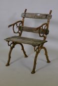 An antique wrought iron single seat garden chair, the cast ends of organic form, with worn wood