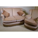 A mid century two seater settee with wing ends and matching chair, well upholstered and in good