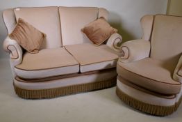 A mid century two seater settee with wing ends and matching chair, well upholstered and in good