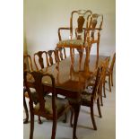 A walnut dining table with carved edge top and ten (8+2) chairs ensuite, 229 x 91cms