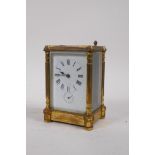 A C19th gilt brass carriage clock with five bevelled glass panels, the enamel dial with Roman