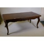 A French oak dining table with parquetry top and pull out end leaves, raised on carved cabriole