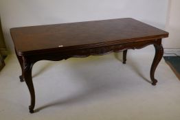 A French oak dining table with parquetry top and pull out end leaves, raised on carved cabriole