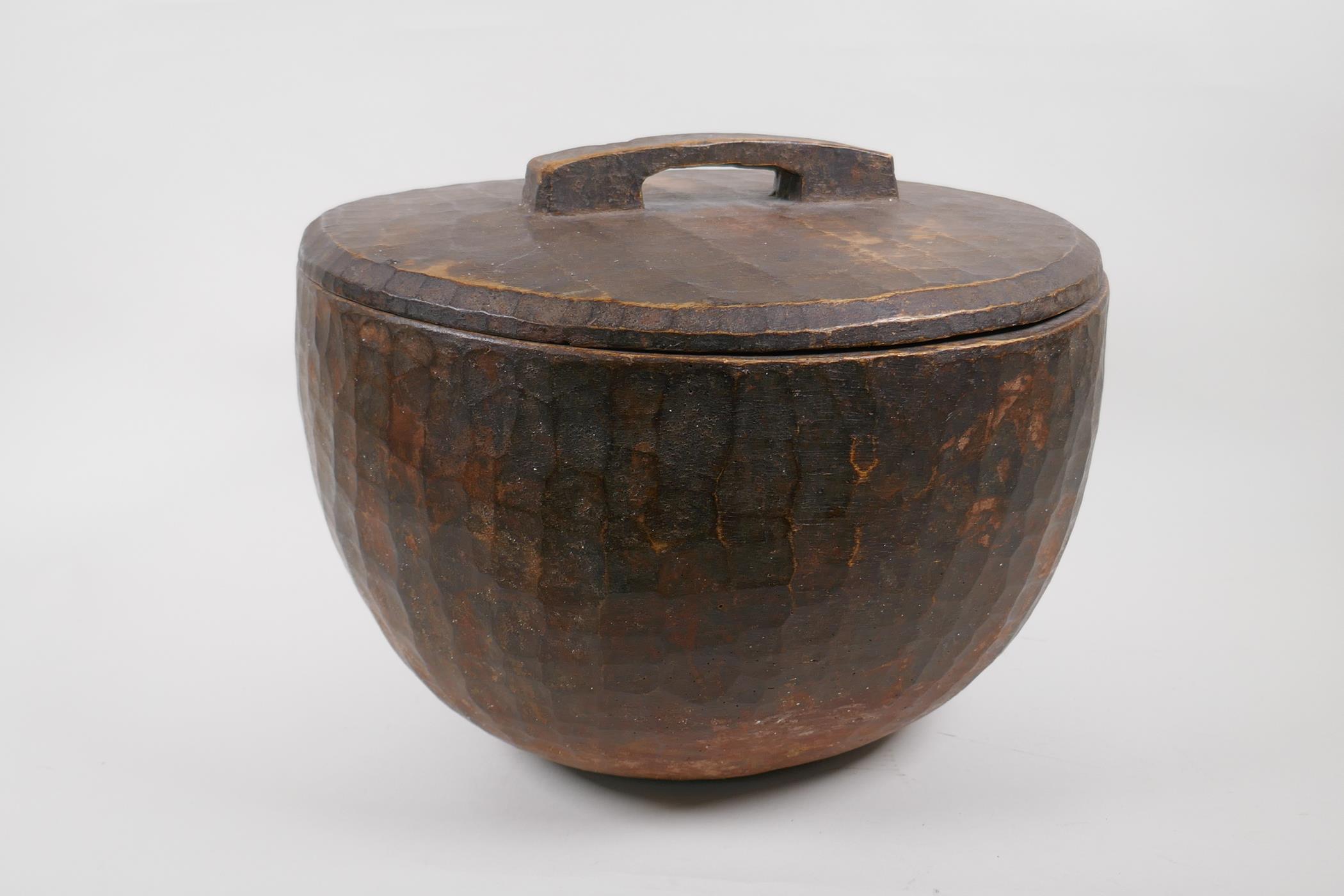 A large African carved wood container and cover, 35cm diameter
