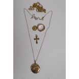 A buckle ring, stamped DW, a gold crucifix and pendant, AF, and a locket