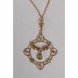 A 9ct gold pendant set with seed pearls and a green stone on a gilt chain, 3.8g