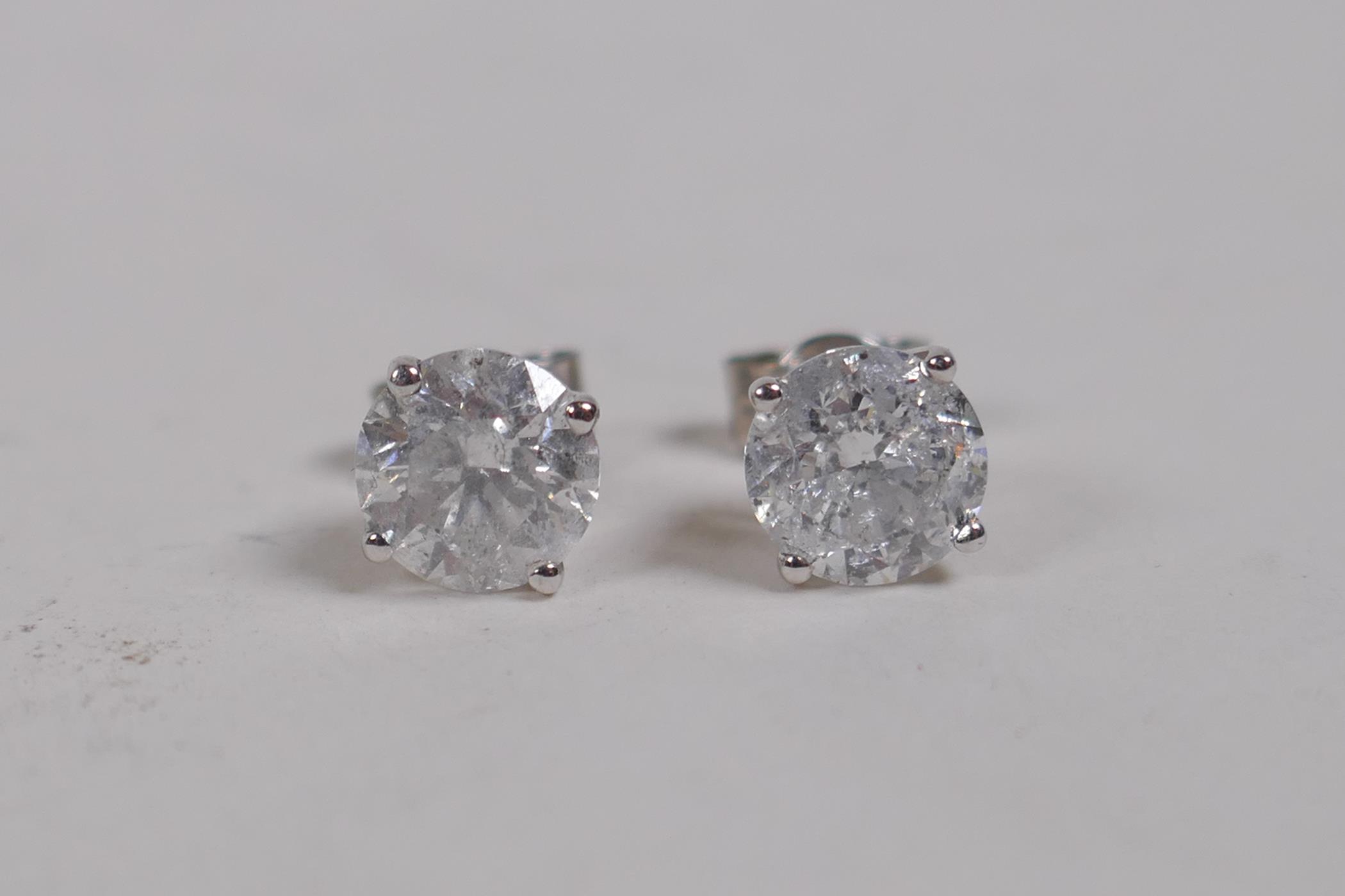 A pair of 18ct white gold and diamond stud earrings, approx 2.1cts