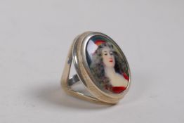 A 925 silver ring set with an enamel panel depicting a girl in red, approx size N/O