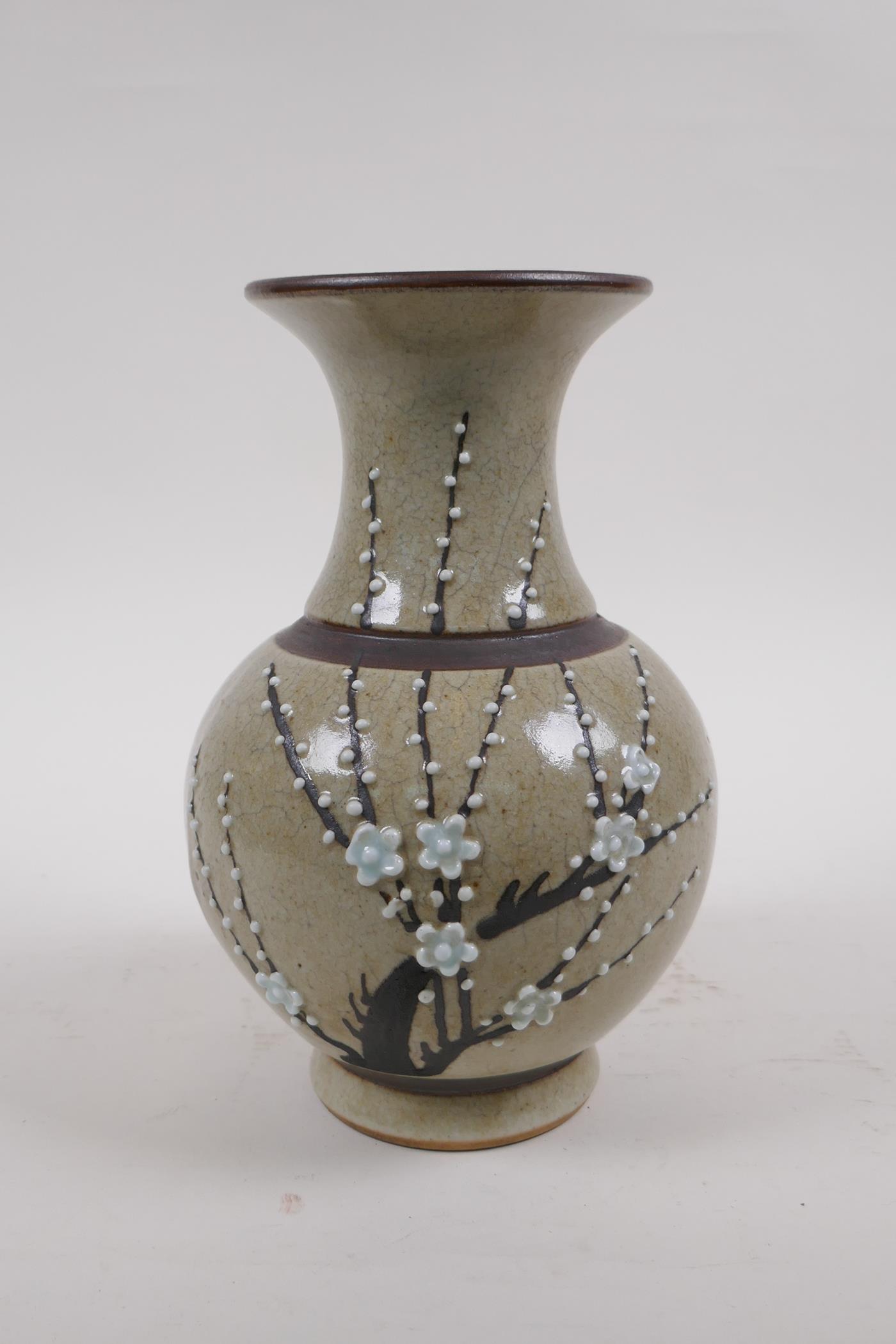 A Chinese celadon glazed porcelain vase with bronze style bands and prunus blossom decoration,