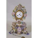 A French porcelain mantel clock with hand painted and gilded decoration, the enamel dial inscribed