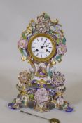 A French porcelain mantel clock with hand painted and gilded decoration, the enamel dial inscribed