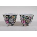 A pair of late C19th/early C20th famille noir porcelain tea bowls with floral decoration, Chinese